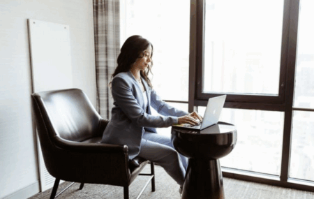 Business Access woman on laptop by a window