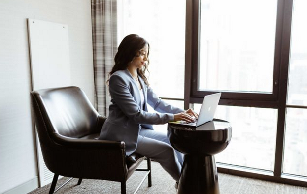 Business Access woman on laptop by a window